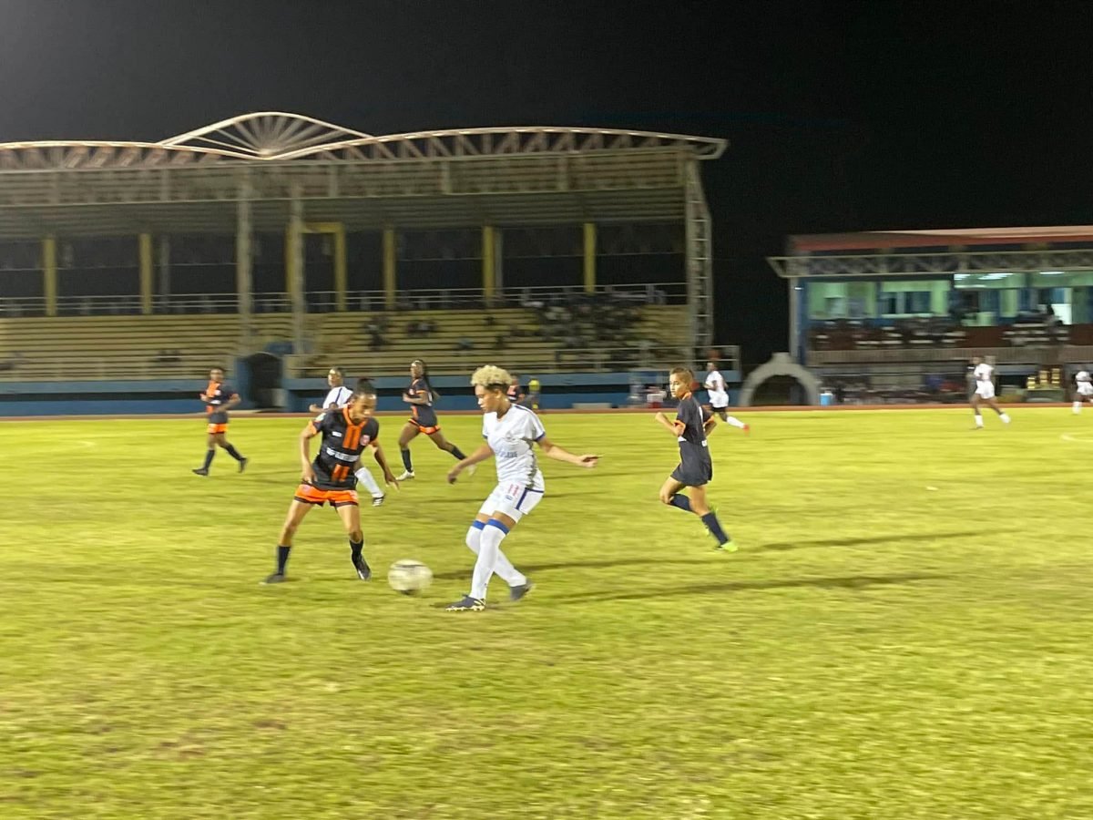 GPF’s Lakeisha Pearson (centre) attempting to dribble her Fruta Conquerors marker in the semi-final round of the GFF/GNWFA Super-16 Women’s Festival at the National Track and Field Centre, Leonora