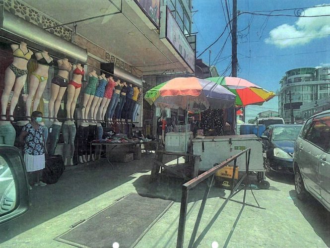 Some of vendors had placed carts and tables with their wares along the pavement outside of the Shamdas Kirpalani building on Regent Street, Georgetown