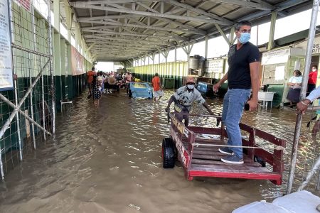 A passenger about to be transported through the flooded stelling