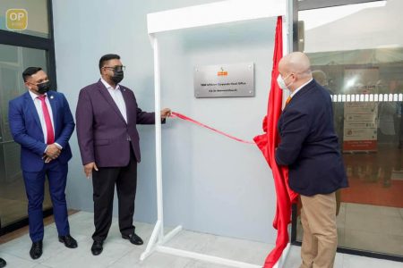 President Irfaan Ali (second from left) and General Manager of SBM Offshore, Francesco Prazzo (right) unveil the plaque as the company’s corporate office was officially opened. Minister of Natural Resources looks on (Office of the President photo) 