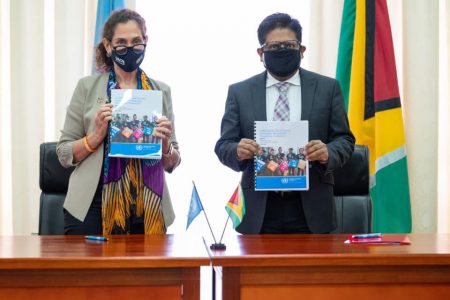 UN Resident Coordinator, Yeşim Oruç, and Minister of Finance Dr Ashni Singh display copies of the 2022-2026 Multi-Country Sustainable Development Cooperation Framework to which Guyana signed on yesterday at the Arthur Chung Conference Centre (Ministry of Finance photo) 