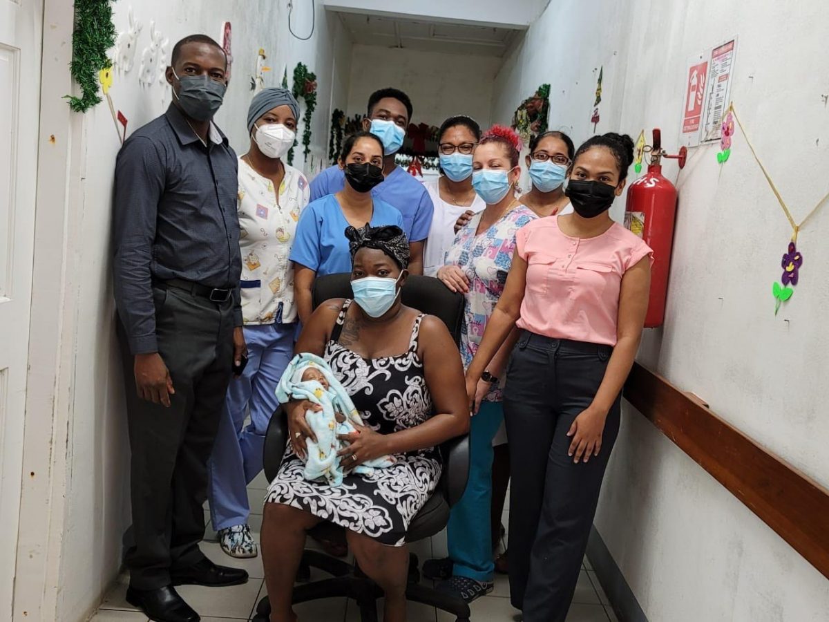 The mother and her baby with health care workers at the Suddie Public Hospital