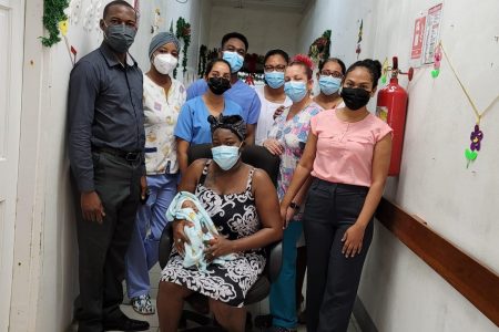 The mother and her baby with health care workers at the Suddie Public Hospital