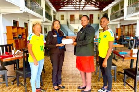 GNWFA President Andrea Johnson (2nd from left) receives the sponsor cheque from Grand Coastal Hotel’s Human Resources Manager Maria Khan in the presence of two players.