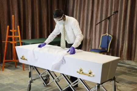 A Dass funeral home worker during preparations