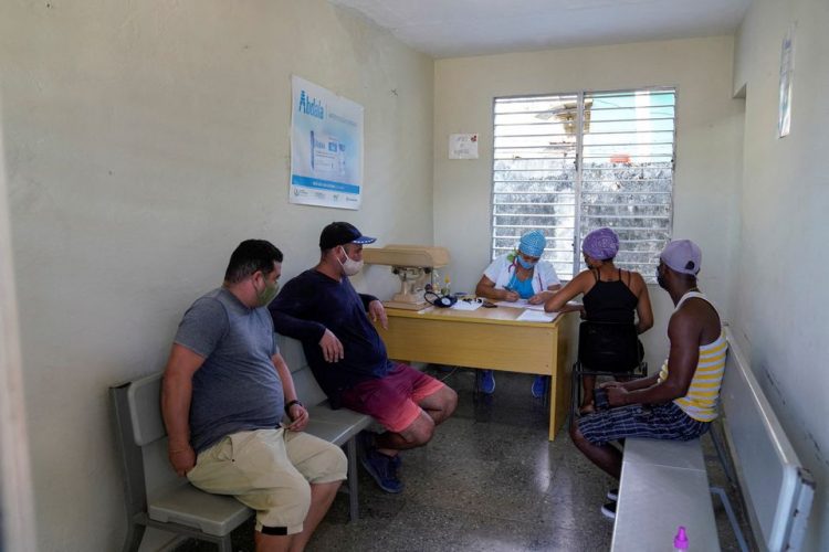 People wait to receive booster doses of the Abdala vaccine against the coronavirus disease (COVID-19), in Havana, Cuba, December 10, 2021. Picture taken December 10, 2021. REUTERS/Natalia Favre