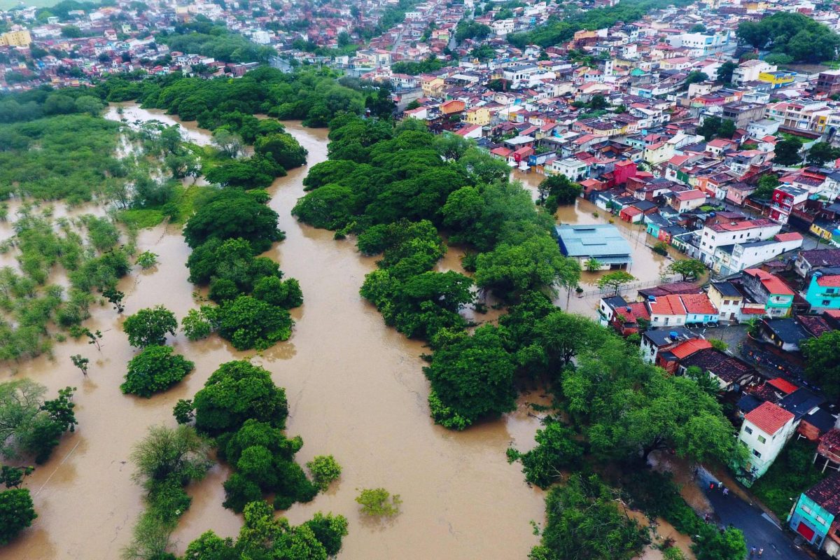 Aerial view of floods caused by heavy rains in Itapetinga, Bahia State, Brazil, on December 26, 2021. – The death toll from heavy rains that have battered the Brazilian state of Bahia since November rose to 18 on Sunday, amid incessant torrents that have displaced 35,000 people, authorities said. Two people are also missing, while 19,580 have been displaced and another 16,001 forced to seek shelter, bringing the number of people driven from their homes to 35,000, the Bahia civil protection agency Sudec said. (Photo by Manuella LUANA / AFP)