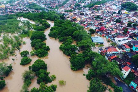 Aerial view of floods caused by heavy rains in Itapetinga, Bahia State, Brazil, on December 26, 2021. - The death toll from heavy rains that have battered the Brazilian state of Bahia since November rose to 18 on Sunday, amid incessant torrents that have displaced 35,000 people, authorities said. Two people are also missing, while 19,580 have been displaced and another 16,001 forced to seek shelter, bringing the number of people driven from their homes to 35,000, the Bahia civil protection agency Sudec said. (Photo by Manuella LUANA / AFP)
