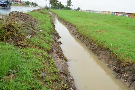 Trenches have been dug along the East Coast Highway to battle the flooding of the road that routinely occurs when there is heavy rain. (Orlando Charles photo)
