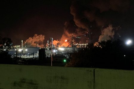 View from the road of a fire at petrochemical company ExxonMobil's refinery near Houston in Baytown, Texas, U.S., December 23, 2021 in this image obtained from social media. Molly Fitzpatrick via REUTERS