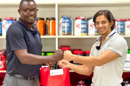 GFF Assistant Technical Director Bryan Joseph (left) receives the hampers from Fitness Express Manager and owner Jamie McDonald.
