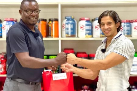 GFF Assistant Technical Director Bryan Joseph (left) receives the hampers from Fitness Express Manager and owner Jamie McDonald.
