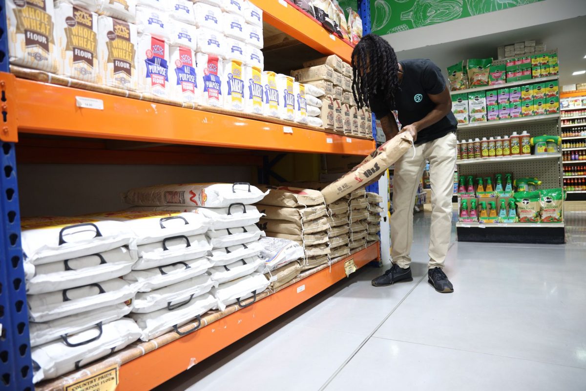 Tyreke Manpaul of Marabella, purchases a sack of IBIS flour from Anand Low Price Supermarket, in South Park Plaza, in San Fernando, yesterday. 