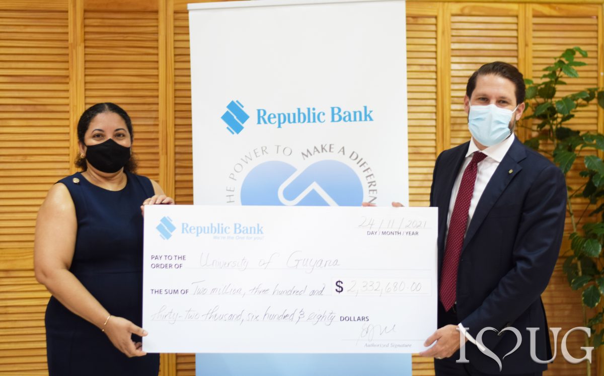 The cheque being handed over by Managing Director Stephen Grell (right) to Vice Chancellor  Professor Paloma Mohamed Martin (UG photo)