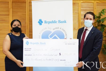 The cheque being handed over by Managing Director Stephen Grell (right) to Vice Chancellor  Professor Paloma Mohamed Martin (UG photo)
