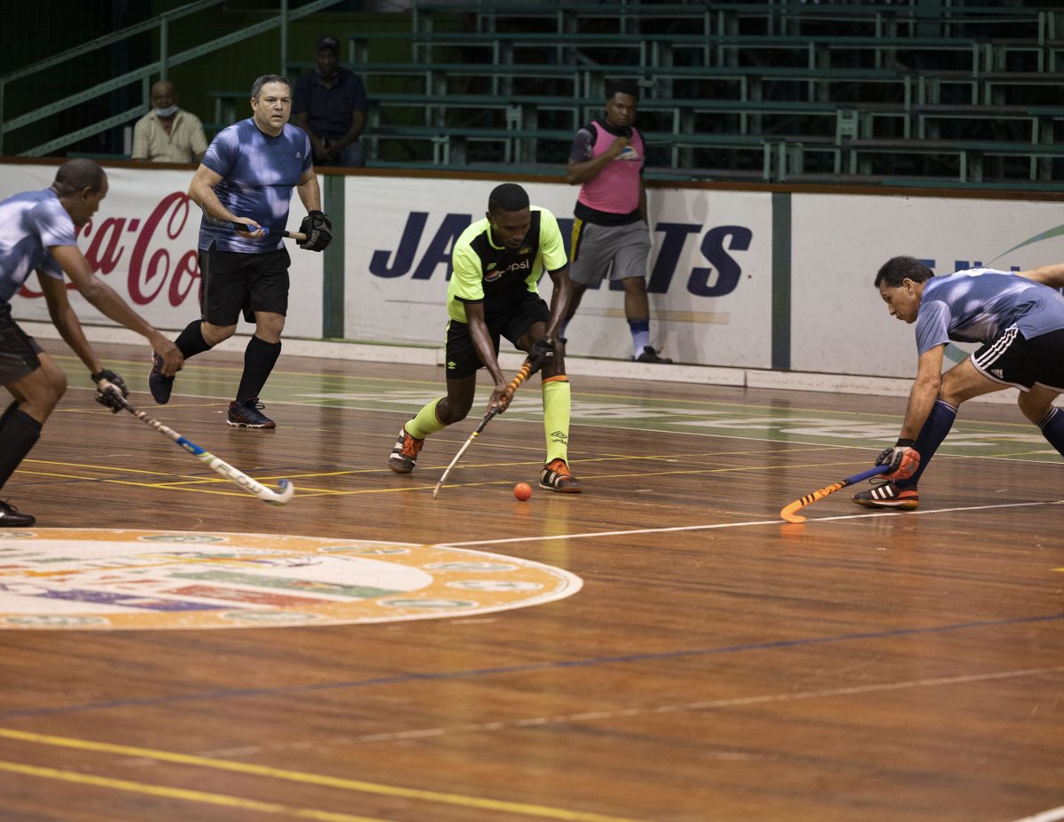 Pepsi Hikers talisman Jamarj Assanah (centre) on the attack while being surrounded by three 50 Not Out players during their men’s first-division clash on Monday night at the Cliff Anderson Sports Hall.
