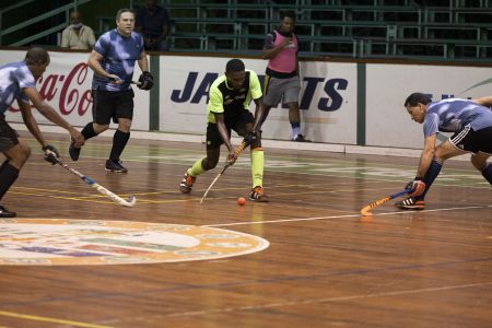 Pepsi Hikers talisman Jamarj Assanah (centre) on the attack while being surrounded by three 50 Not Out players during their men’s first-division clash on Monday night at the Cliff Anderson Sports Hall.
