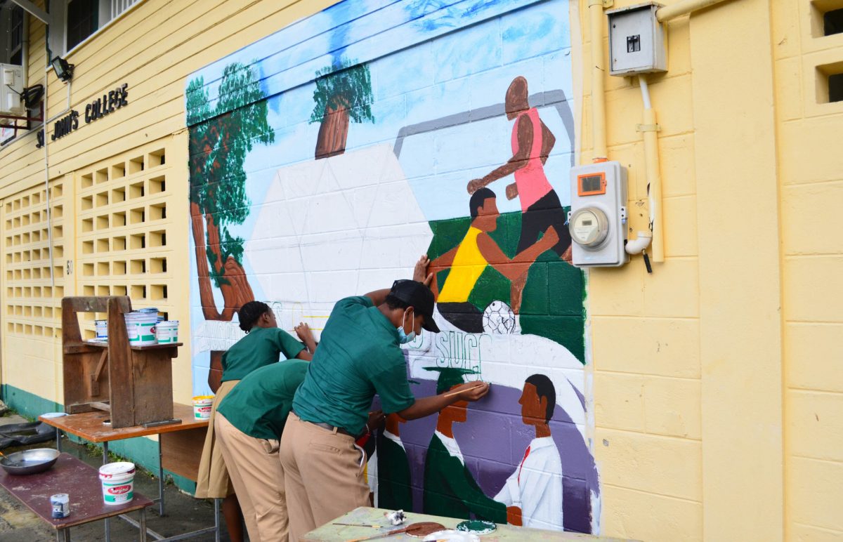 A story in art: Mural painting at St John’s College on Waterloo Street yesterday. (Orlando Charles photo)