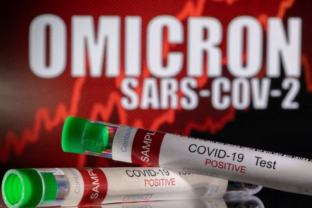 FILE PHOTO: Test tubes labelled "COVID-19 Test Positive" are seen in front of displayed words "OMICRON SARS-COV-2" in this illustration taken December 11, 2021. REUTERS/Dado Ruvic/Illustration