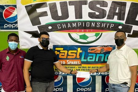 Fast Lane Auto Spares’ General Manager, in the presence of Alwin Padmore, hands over the sponsorship cheque to Kashif Muhammad (right) for the K&S Futsal tournament.