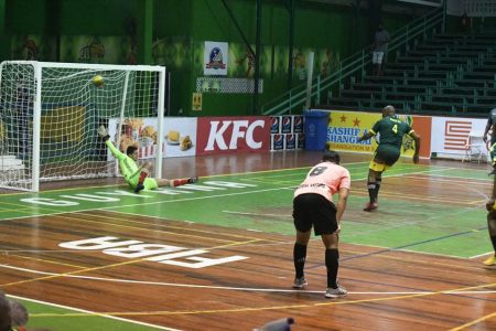 Shem Porter of Alexander Village scoring from the penalty spot against Avocado Ballers in the GFF/Kashif
and Shanghai Organization Futsal Championship at the Cliff Anderson Sports Hall on Homestretch Avenue