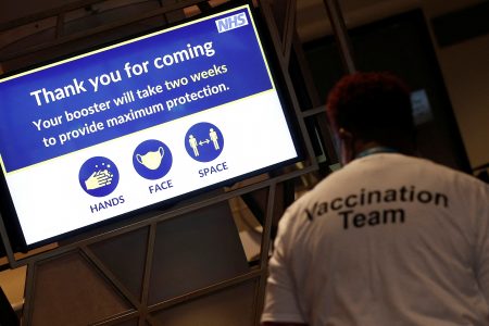 A NHS message is seen on a screen at a coronavirus disease (COVID-19) pop-up vaccination centre at Wembley Stadium in London, Britain, December 19, 2021.  REUTERS/Peter Nicholls