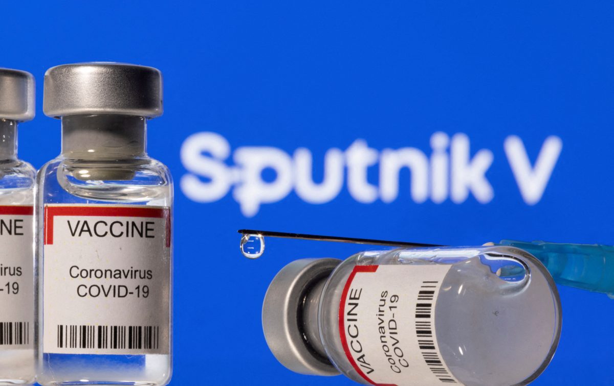 FILE PHOTO: Vials labelled "VACCINE Coronavirus COVID-19" and a syringe are seen in front of a displayed Sputnik V logo in this illustration taken December 11, 2021. REUTERS/Dado Ruvic