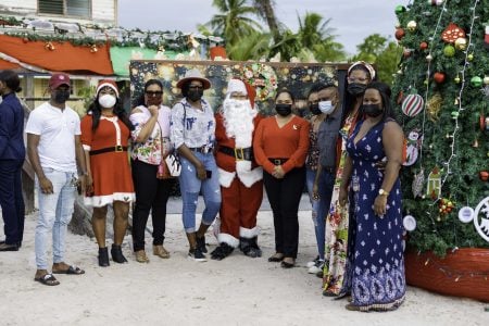 First Lady, Arya Ali (fifth from right) partnered with the Give Another Chance Foundation on Saturday to distribute toys to 500 children from the Essequibo River island of Wakenaam and light a 12-feet Christmas tree.
The visit on Saturday marked Mrs Ali’s second appearance on the island since becoming First Lady. She had visited earlier in the year to distribute hampers to roughly 100 senior citizens, a release from her office said.
The  programme began with Mrs Ali and a group of children decorating the Christmas tree with ‘One Guyana’ ornaments. The tree was erected in the Arthurville Primary School compound and was partially decorated by the foundation and residents of island before Mrs Ali’s arrival, the release added.