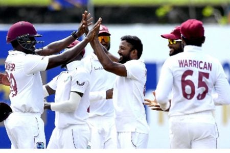 Nkrumah Bonner (left) celebrates a wicket with left-arm spinner Veerasammy Permaul on yesterday’s second day of the second Test