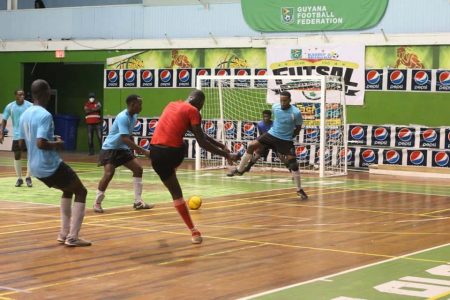 Kevon Williams of Berbice scoring against Mocha Ballers in the GFF/Kashif and Shanghai Organization Futsal Championship at the Cliff Anderson Sports Hall Saturday night.