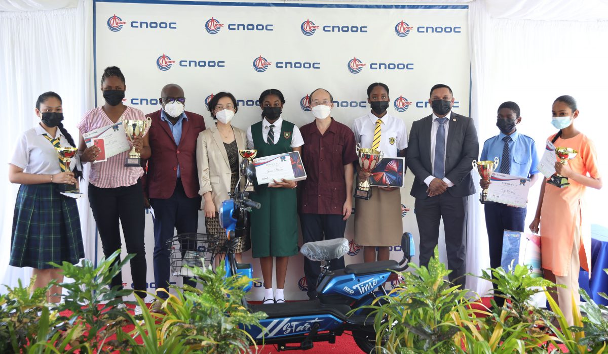Essay competition winners with Chief Education Officer, CPGL’s President and the Minister of Natural Resources