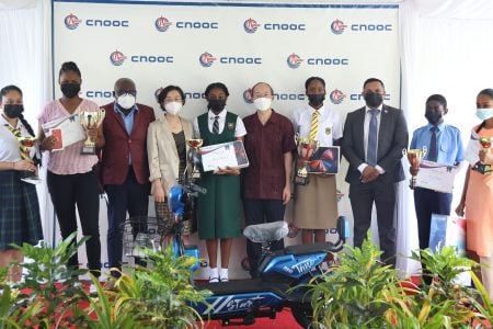 Essay competition winners with Chief Education Officer, CPGL’s President and the Minister of Natural Resources