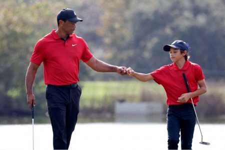 Tiger Woods of the U.S. and his son Charlie on the 12th hole the during second round REUTERS/Joe Skipper