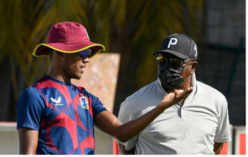 Chief selector The Most Honourable Desmond Haynes (right) chats with left-arm spinner Akeal Hosein during the T20 series against England at Kensington Oval. 