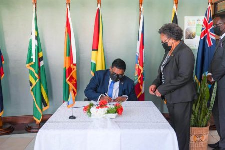 President Irfaan Ali signs the handover certificate (Office of the President photo)