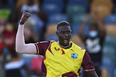Fast bowler Jason Holder celebrates one of his four wickets against England yesterday