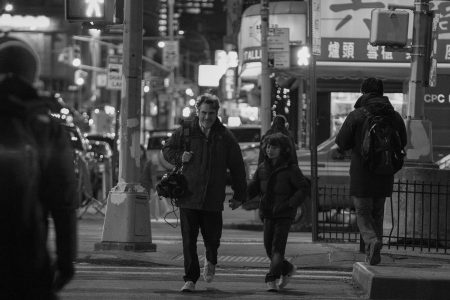 Woody Norman and Joaquin Phoenix walk through the streets in C’mon C’mon