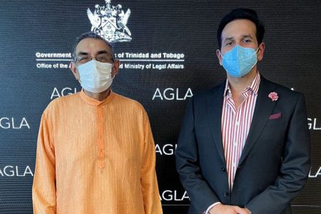 Attorney General Faris Al-Rawi (right) with a representative of the Hindu community