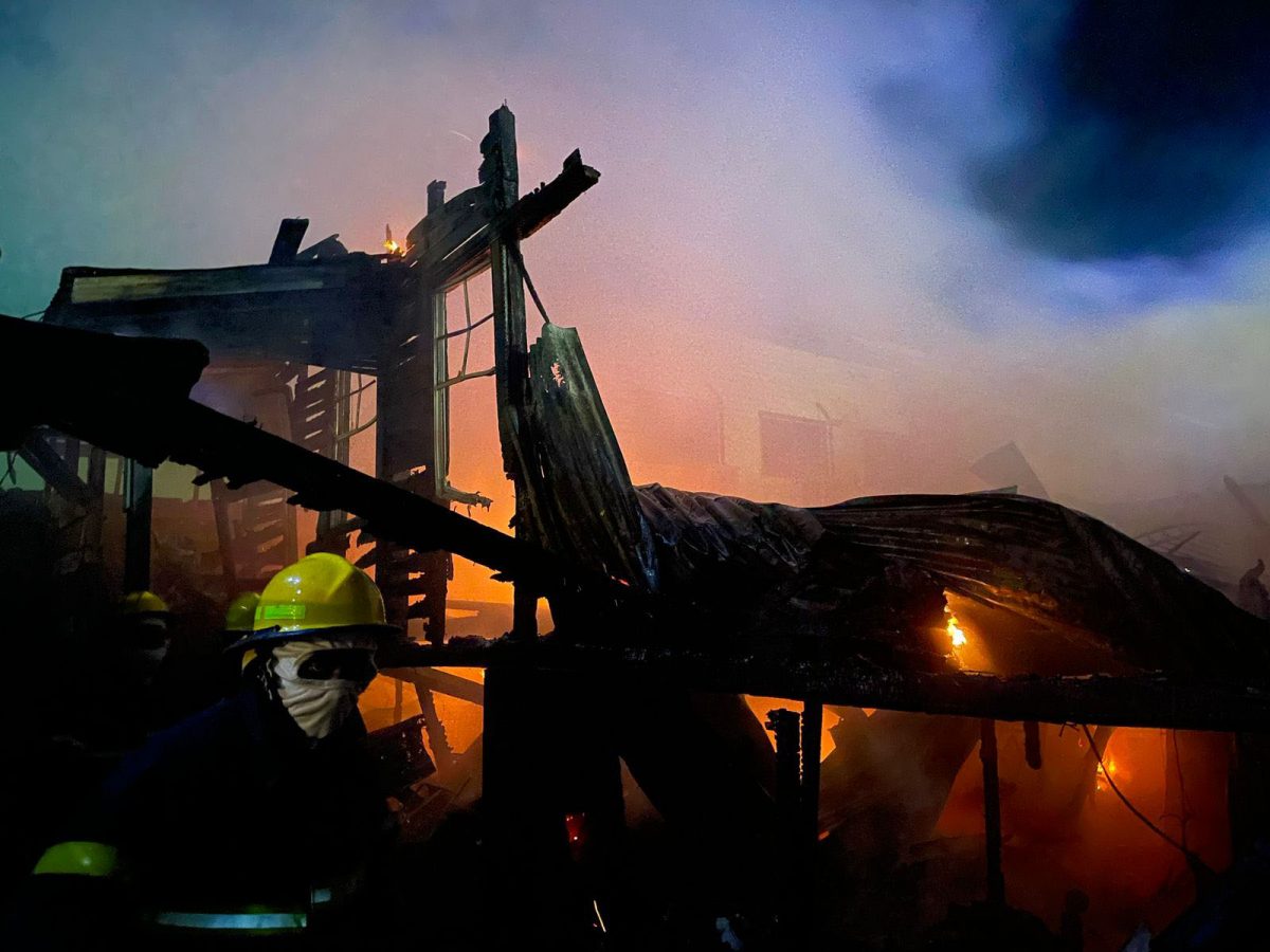 A firefighter stands near the remains of the building after the fire was contained (David Papannah photo)