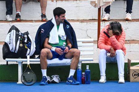  Serbian tennis player Novak Djokovic talks to his assistant Pepe Imaz during a training session at Puente Romano Tennis Club in Marbella, Spain, January 3, 2022. Picture taken January 3, 2022. KMJ-GTRES/Handout via REUTERS