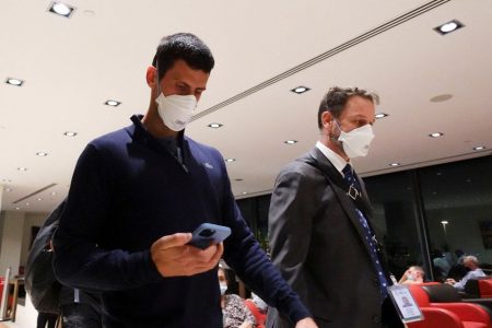 Serbian tennis player Novak Djokovic walks in Melbourne Airport before boarding a flight, after the Federal Court upheld a government decision to cancel his visa to play in the Australian Open, in Melbourne, Australia, yesterday. REUTERS/Loren Elliott.