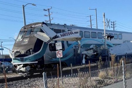 A train hits an aircraft that crashed on railway tracks in Los Angeles, California, U.S. January 9, 2022 in this screen grab from a social media video obtained by Reuters.