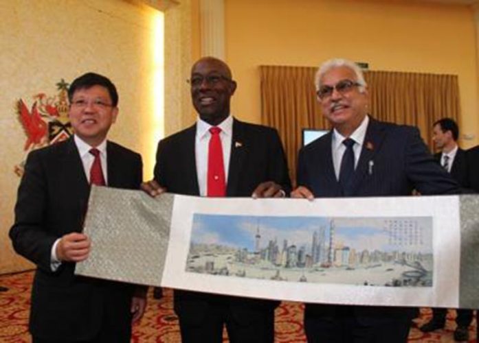 Flashback, May 2019: Prime Minister Dr Rowley, centre, receives a gift from the Deputy Secretary General of Shanghai Municipal People’s Government, Huang Rong, following the signing of the agreement between the Government of Trinidad and Tobago and Shanghai Construction Group Caribbean Ltd at The Diplomatic Centre, St Ann’s, for the construction of the Port of Spain General Hospital Central Block. At right is Health Minister Terrence Deyalsingh.