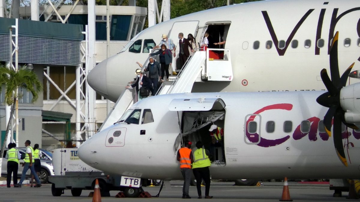 Passengers disembark the Virgin Atlantic Airlines aircraft after it landed at the ANR Robinson International Airport on Saturday.