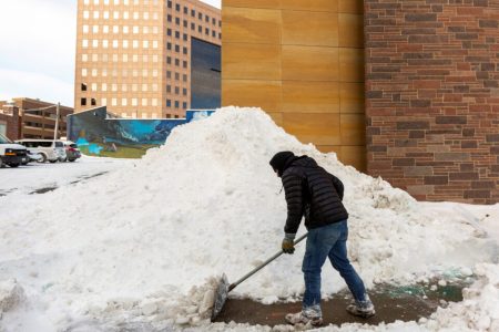A Des Moines resident shovels downtown sidewalks after Winter Storm Izzy in Des Moines, Iowa, U.S., January 15, 2022.    REUTERS/Rachel Mummey