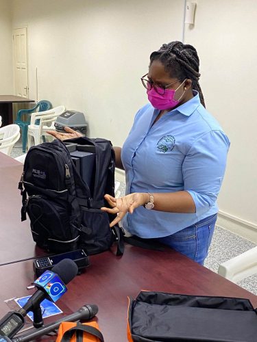 Environmental Officer Gwenetta Fordyce demonstrating how the radiation detection backpack works
