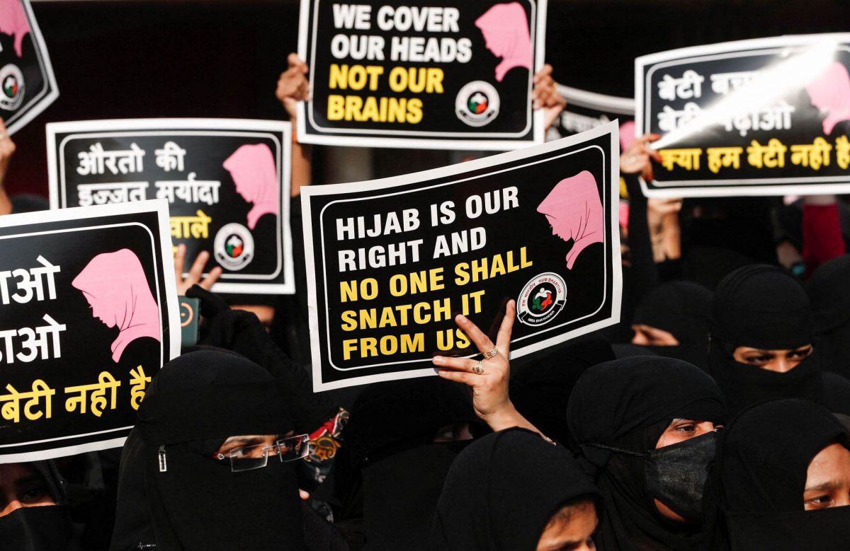 Women hold placards during a protest, organised by Hum Bhartiya, against the recent hijab ban in few colleges of Karnataka state, on the outskirts of Mumbai, India, February 11, 2022. (REUTERS/Francis Mascarenhas photo) 