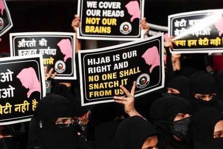 Women hold placards during a protest, organised by Hum Bhartiya, against the recent hijab ban in few colleges of Karnataka state, on the outskirts of Mumbai, India, February 11, 2022. (REUTERS/Francis Mascarenhas photo) 