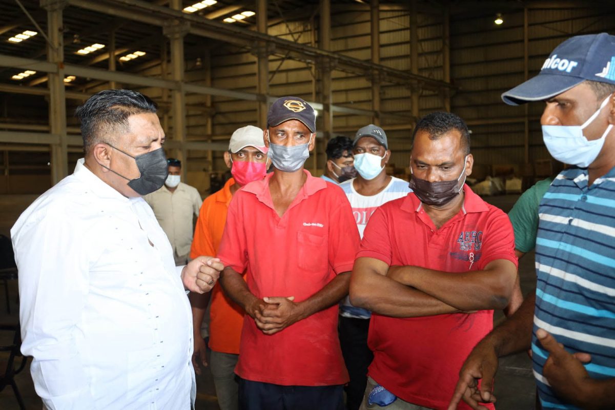 Packaging plant workers assured of jobs at planned Enmore oil field service centre: Minister Zulfikar Mustapha engaging workers at the Enmore packaging plant on Friday. See page 13 for more. (Department of Public Information photo)