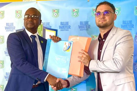 Inked! GFF President Wayne Forde (left) and Richard De Nobrega, Country Manager of Blue Waters Shipping, display the signed MoU which will pave the way for the staging of the Girls U15 Developmental League.